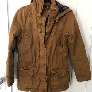 Label of Graded Goods Outerwear Jacket in brown.